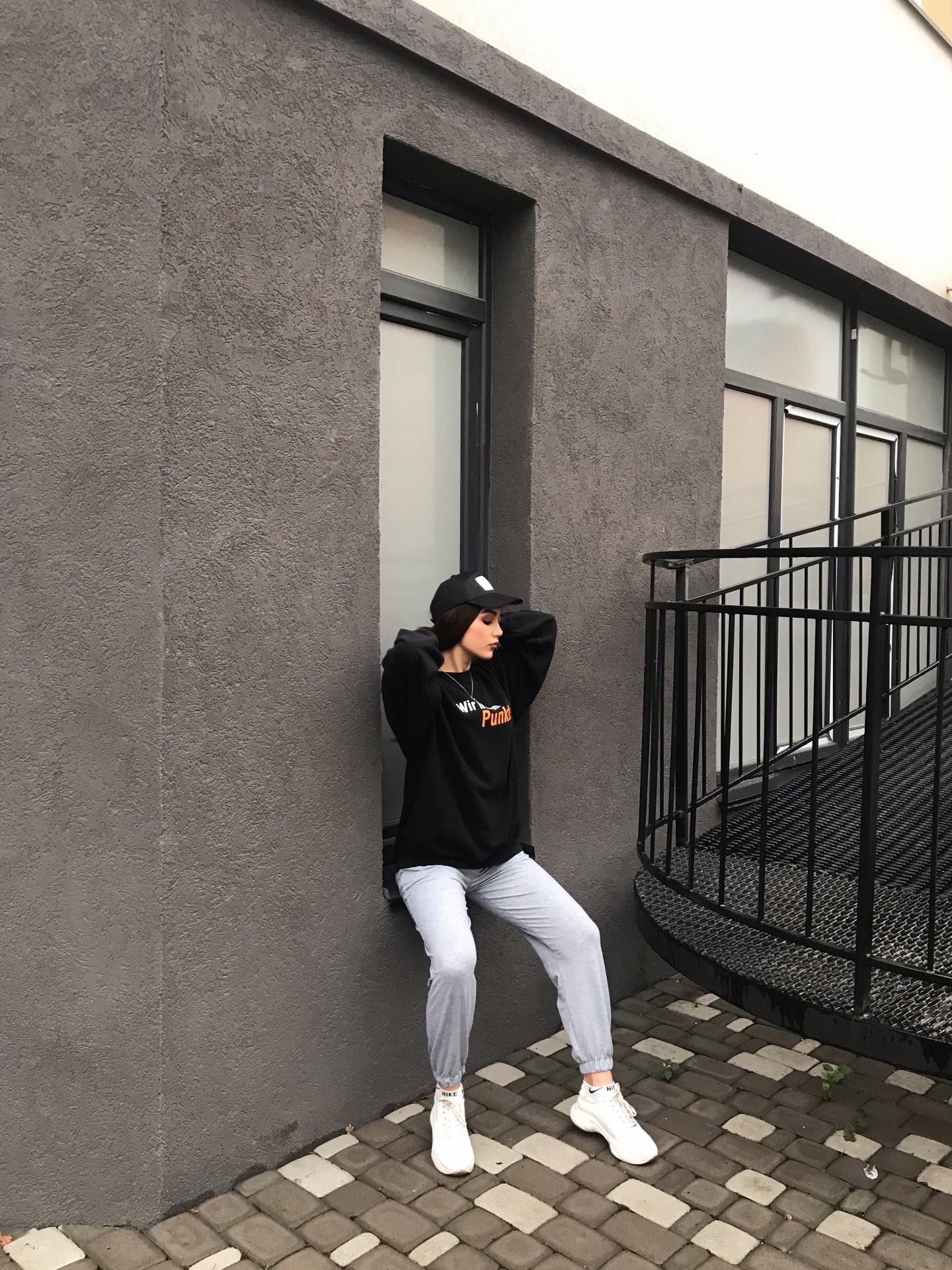 Before: oversized black hoodie, gray sweatpants, white sneakers and cap